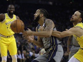 Golden State Warriors' Stephen Curry, right, knocks the ball loose from Indiana Pacers' Cory Joseph (6) during the first half of an NBA basketball game Thursday, March 21, 2019, in Oakland, Calif.