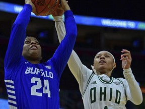 Buffalo guard Cierra Dillard goes to the basket against Ohio guard Cece Hooks during the first half of an NCAA college basketball championship game of the Mid-American Conference women's tournament, Saturday, March 16, 2019, in Cleveland.