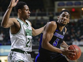 Buffalo guard CJ Massinburg drives on Ohio guard Antonio Cowart Jr. during the first half of an NCAA college basketball game Tuesday, March 5, 2019, in Athens, Ohio.