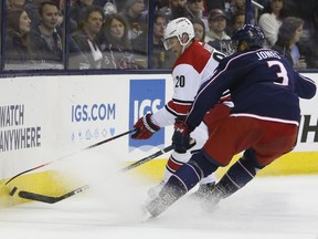 Carolina Hurricanes' Sebastian Aho, left, of Finland, and Columbus Blue Jackets' Seth Jones fight for a loose puck during the first period of an NHL hockey game Friday, March 15, 2019, in Columbus, Ohio.