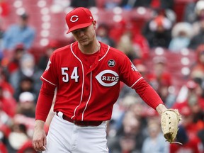 Cincinnati Reds starting pitcher Sonny Gray reacts after giving up a run after walking Pittsburgh Pirates' Trevor Williams with the bases loaded in the third inning of a baseball game, Sunday, March 31, 2019, in Cincinnati.