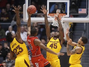 St. John's Mustapha Heron (14) shoots against Arizona State's Romello White (23) and Zylan Cheatham (45) during the first half of a First Four game of the NCAA men's college basketball tournament Wednesday, March 20, 2019, in Dayton, Ohio.