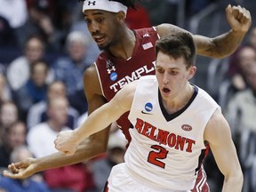 Belmont's Grayson Murphy (2) and Temple's Quinton Rose, left, scramble for the ball during the first half of a First Four game of the NCAA college basketball tournament, Tuesday, March 19, 2019, in Dayton, Ohio.