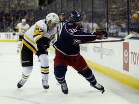 Columbus Blue Jackets forward Boone Jenner, right, chases the puck against Pittsburgh Penguins forward Nick Bjugstad during the first period of an NHL hockey game in Columbus, Ohio, Saturday, March 9, 2019.