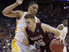 Colgate's Rapolas Ivanauskas, right, drives past Tennessee's Grant Williams in the first half of a first-round game in the NCAA men's college basketball tournament in Columbus, Ohio, Friday, March 22, 2019.