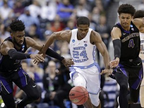 Washington's Jaylen Nowell, left to right, North Carolina's Kenny Williams and Washington's Matisse Thybulle battle for a loose ball in the first half during a second round men's college basketball game in the NCAA Tournament in Columbus, Ohio, Sunday, March 24, 2019.