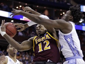 Iona's Tajuan Agee, left, and North Carolina's Nassir Little battle for a rebound in the first half during a first round men's college basketball game in the NCAA Tournament in Columbus, Ohio, Friday, March 22, 2019.