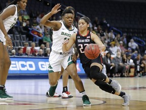 Texas Tech guard Angel Hayden, right, drives to the basket around Baylor guard Moon Ursin during the first half of an NCAA college basketball game in the Big 12 women's conference tournament in Oklahoma City, Saturday, March 9, 2019.
