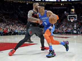 Oklahoma City Thunder guard Russell Westbrook, right, drives Portland Trail Blazers guard Damian Lillard during the first half of an NBA basketball game in Portland, Ore., Thursday, March 7, 2019.