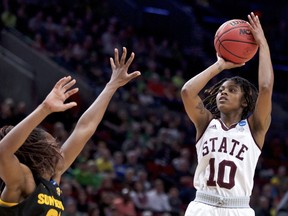 Mississippi State guard Jazzmun Holmes, right, shoots over Arizona State forward Sophia Elenga during the first half of a regional semifinal in the NCAA women's college basketball tournament Friday, March 29, 2019, in Portland, Ore.