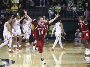 Indiana's Ali Patberg, center, starts the celebration with teammate Bendu Yeaney, right, after Indiana defeated Texas in an NCAA women's college basketball tournament game Friday, March 22, 2019, in Eugene, Ore.