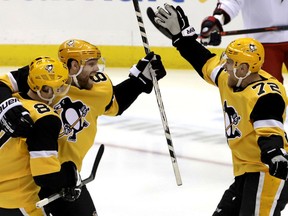 Pittsburgh Penguins' Phil Kessel, second from left, celebrates his goal with Sidney Crosby (87) and Patric Hornqvist (72) during the first period of the team's NHL hockey game against the Columbus Blue Jackets in Pittsburgh, Thursday, March 7, 2019.