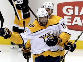 Nashville Predators' Craig Smith (15) celebrates his goal with Calle Jarnkrok (19) during the first period of an NHL hockey game against the Pittsburgh Penguins in Pittsburgh, Friday, March 29, 2019.