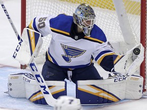 St. Louis Blues goaltender Jordan Binnington gloves a shot during the first period of an NHL hockey game against the Pittsburgh Penguins in Pittsburgh, Saturday, March 16, 2019.