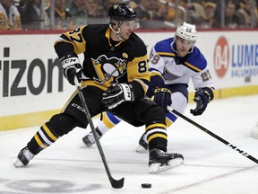 Pittsburgh Penguins' Sidney Crosby (87) looks to get off a backhand shot with St. Louis Blues' Vince Dunn (29) defending during the second period of an NHL hockey game in Pittsburgh, Saturday, March 16, 2019.