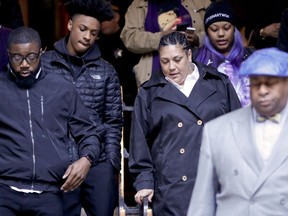 Michelle Kenney, center, the mother of Antwon Rose II, leaves the Allegheny County Courthouse with supporters after testimony on the first day of the trial for Michael Rosfeld, a former police officer in East Pittsburgh, Pa., on Tuesday, March 19, 2019, in Pittsburgh. Rosfeld is charged with homicide in the fatal shooting of Antwon Rose II as he fled during a traffic stop on June 19, 2018.