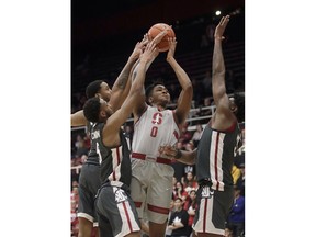Stanford forward KZ Okpala (0) shoots between Washington State defenders during the first half of an NCAA college basketball game in Stanford, Calif., Thursday, Feb. 28, 2019.