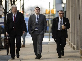 Former East Pittsburgh police officer Michael Rosfeld, center, charged with homicide in the shooting death of Antwon Rose II, arrives at the Dauphin County Courthouse in Harrisburg, Pa., Tuesday, March 12, 2019.