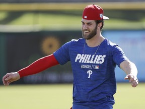 Philadelphia Phillies outfielder Bryce Harper warms up during baseball practice Sunday, March 3, 2019, at Spectrum Field in Clearwater, Fla.