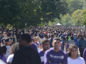 Students donned in traditional Western University hoodies stream across Broughdale Avenue as part of a FOCO (fake homecoming) street party in London, Ont.