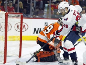 Washington Capitals' Lars Eller gets the puck past Philadelphia Flyers goalie Carter Hart for a goal during the first period of an NHL hockey game Thursday, March 14, 2019, in Philadelphia.