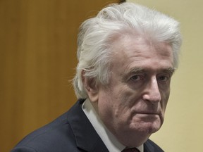 Former Bosnian Serb leader Radovan Karadzic enters the court room of the International Residual Mechanism for Criminal Tribunals in The Hague, Netherlands, Wednesday, March 20, 2019. Nearly a quarter of a century since Bosnia's devastating war ended, Karadzic is set to hear the final judgment on whether he can be held criminally responsible for unleashing a wave of murder and destruction. United Nations appeals judges will on Wednesday rule whether to uphold or overturn Karadzic's 2016 convictions for genocide, crimes against humanity and war crimes, as well as his 40-year sentence.