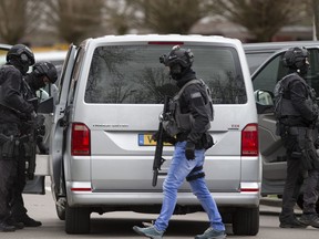 Dutch counter terrorism police prepare to enter a house after a shooting incident in Utrecht, Netherlands, Monday, March 18, 2019. A gunman killed three people and wounded nine others on a tram in the central Dutch city of Utrecht, sparking a manhunt that saw heavily armed officers with sniffer dogs zero in on an apartment building close to the shooting.