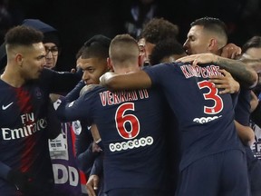 Teammates congratulate PSG's Kylian Mbappe, second left, after he scored his side's first goal during their French League One soccer match between Paris-Saint-Germain and Olympique Marseille at the Parc des Princes stadium in Paris, Sunday, March 17, 2019.