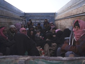 Men, women and children are crowded in convoys of trucks going back and forth from Baghouz, rescuing civilians trapped in the crossfire between remaining jihadists and SDF forces.