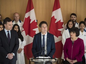 Bill Morneau, Minister of Finance, left to right, Dr. Eric Hoskins, Chair of the Advisory Council on the Implementation of National Pharmacare and Ginette Petitpas Taylor, federal Minister of Health, attend a press conference on the national pharmacare program at the Li Ka Shing Knowledge Institute in Toronto on Wednesday, March 6, 2019.