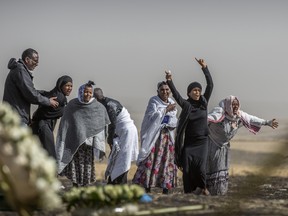 Ethiopian relatives of crash victims grieve at the site where the Ethiopian Airlines Boeing 737 Max 8 crashed shortly after takeoff on March 10 killing all 157 on board.