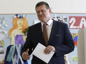 In this file picture taken on Saturday, March 16, 2019, Presidential candidate Maros Sefcovic prepares to cast his vote at a polling station during the first round of the presidential election in Bratislava, Slovakia. Slovakia could get its first woman president as voters elect a new head of state on Saturday March 30. The leading contenders are Zuzana Caputova, an environmental activist who is in favor of gay rights and opposes a ban on abortion in this conservative Roman Catholic country, and Maros Sefcovic, an establishment figure who is the European Commission Vice-President.