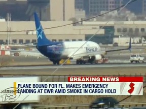 In this image taken from video provided by News12 New Jersey, Air Transat Flight 942 is towed along the runway at Newark Liberty International Airport.