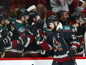Arizona Coyotes defenseman Oliver Ekman-Larsson (23) celebrates his goal against the Detroit Red Wings with teammates on the bench during the first period of an NHL hockey game Saturday, March 2, 2019, in Glendale, Ariz.