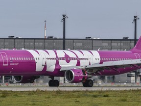 File---Picture taken Sept.12, 2017 shows an aircraft of Icelandic airline WOW that is parked at the airport in Schoenfeld, Germany.