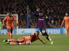 Lyon's Marcelo, left challenges for the ball with Barcelona's Lionel Messi during the Champions League round of 16, 2nd leg, soccer match between FC Barcelona and Olympique Lyon at the Camp Nou stadium in Barcelona, Spain, Wednesday, March 13, 2019.