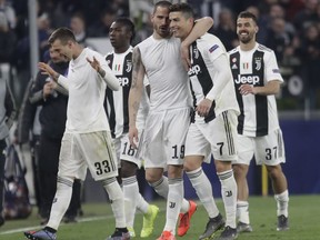 Juventus' Leonardo Bonucci, centre left and Cristiano Ronaldo hug at the end of the Champions League round of 16, 2nd leg, soccer match between Juventus and Atletico Madrid at the Allianz stadium in Turin, Italy, Tuesday, March 12, 2019.