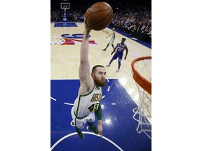 Boston Celtics' Aron Baynes goes up for a dunk during the first half of the team's NBA basketball game against the Philadelphia 76ers, Wednesday, March 20, 2019, in Philadelphia.