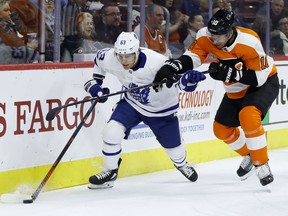 Toronto Maple Leafs' Tyler Ennis, left, tries to keep the puck away from Philadelphia Flyers' Corban Knight during the first period of an NHL hockey game Wednesday, March 27, 2019, in Philadelphia.