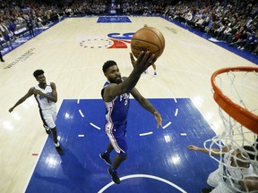 Philadelphia 76ers' Amir Johnson (5) goes up for a shot past Orlando Magic's Jonathan Isaac (1) during the first half of an NBA basketball game, Tuesday, March 5, 2019, in Philadelphia.