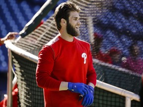 Philadelphia Phillies' Bryce Harper pulls on his gloves for batting practice, Tuesday, March 26, 2019, in Philadelphia.