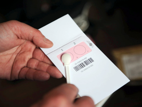 The departemental director of public safety, Olivier Le Gouestre, shows the DNA kit during a press conference at La Rochelle tribunal, western France, on April 14, 2014.