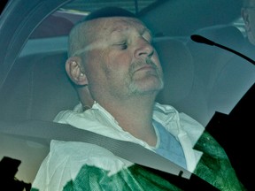 Richard Henry Bain arrives at the Montreal courthouse in the back of a police car on Sept. 6, 2012, two days after killing a man and badly injuring another in shootings at a Partis Quebecois election victory party at the Metropolis in downtown Montreal.