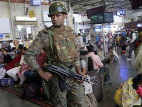 An Indian police officer keeps guard at Chhatrapati Shivaji Terminus railway station in Mumbai, India, Thursday, Feb. 28, 2019. Pakistan's prime minister pledged on Thursday his country would release a captured Indian jetfighter pilot the following day, a move that could help defuse the most-serious confrontation in two decades between the nuclear-armed neighbors over the disputed region of Kashmir. An Indian government official, speaking on condition of anonymity as he was not authorized to speak publicly, warned that even if the pilot is returned home, New Delhi would not hesitate to strike its neighbor first if it feared a similar militant attack was looming.