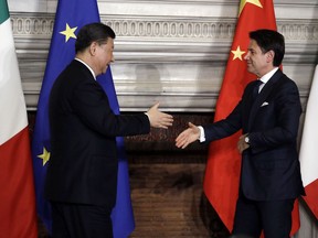 Chinese President Xi Jinping, left, and Italian Premier Giuseppe Conte shake their hands at the end of the signing ceremony of a memorandum of understanding at Rome's Villa Madama, Saturday, March 23, 2019. Italy signed a memorandum of understanding with China on Saturday in support of Beijing's "Belt and Road" initiative, which aims to weave a network of ports, bridges and power plants linking China with Africa, Europe and beyond.