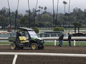 Investigators test the track surface at Santa Anita Park in Santa Anita, Calif. on Thursday March 7, 2019. Santa Anita has canceled horse racing indefinitely to re-examine its dirt surface after the deaths of 21 horses in the last two months.
