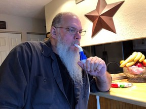 Retired coal miner John Robinson uses a nebulizer during his daily breathing treatments for black lung disease on Thursday, Jan. 24, 2019 in Coeburn, Va. Robinson was 47 when he was diagnosed with black lung disease, part of a new generation of black lung sufferers who are contracting the deadly disease at younger ages.