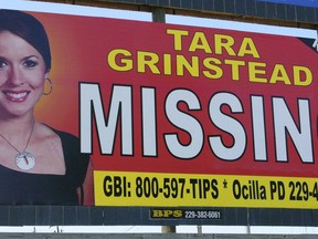 FILE - In this Wednesday, Oct. 4, 2006 file photo, missing teacher Tara Grinstead is displayed on a billboard in Ocilla, Ga. A Georgia man is standing trial on charges that he helped conceal the death of Tara Grinstead, who disappeared more than 13 years ago. Bo Dukes is charged with concealing a death, hindering the apprehension of a felon and lying to police after Tara Grinstead vanished from her home in rural Irwin County in October 2005. His trial began Monday, March 18, 2019.