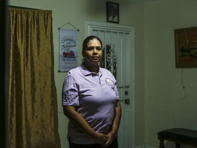 In this Thursday, March 28, 2019 photo, Wanda Gomez, a survivor of domestic violence, poses in her home, in Miami, Fla. According to Gomez, 12 years have passed since she was nearly stabbed to death by an ex-boyfriend. Following her assault, she was advised by authorities to quit her job and leave her home. She lost her ability to make a living and provide a safe living environment for her family. Gomez said she could have benefited from a bill currently making its way through Florida Legislature. If passed, the law would grant victims of domestic violence the right to receive unemployment compensation. According to data, 41 states across the U.S. provide unemployment benefits to victims of domestic assault.