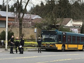 Investigators work on the scene of a shooting in Seattle on Wednesday, March 27, 2019. Authorities say four people, including a Metro bus driver, were shot and one person has been detained.